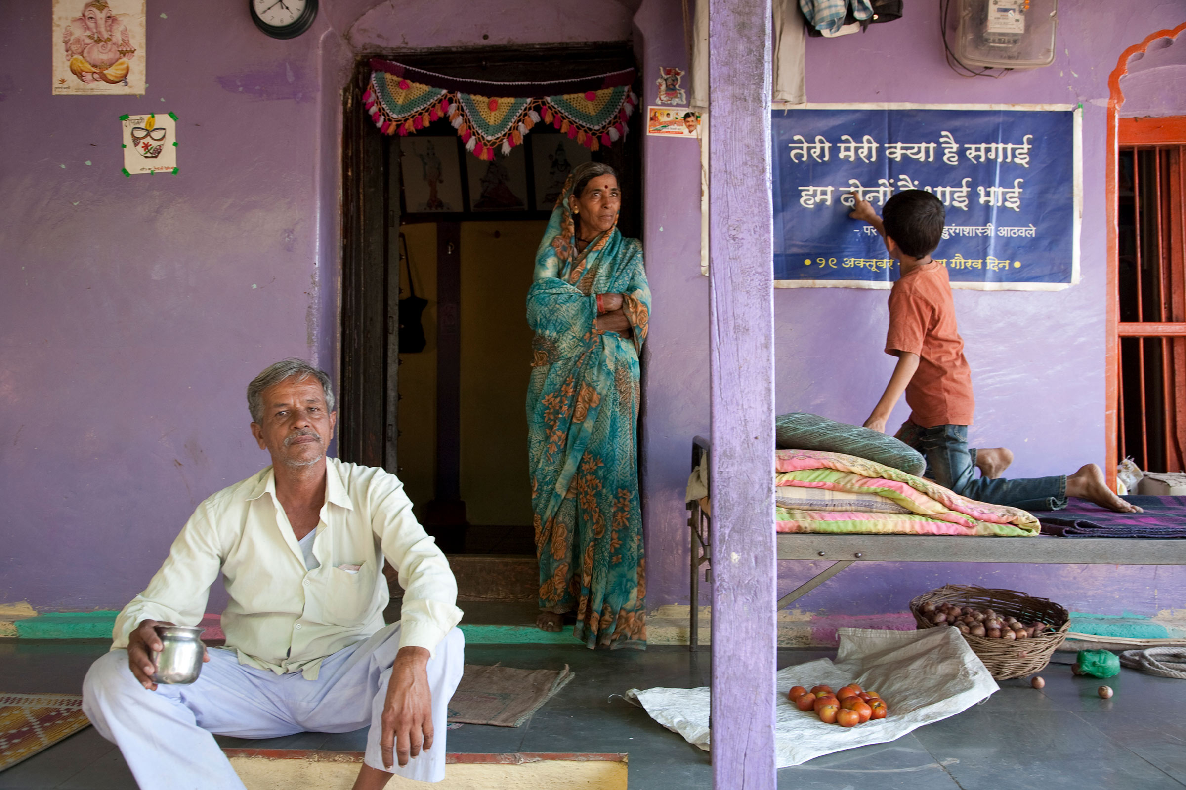 Man, woman and child infront of house